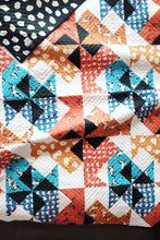 Load image into Gallery viewer, The Weekend Quilter Wind Tunnel Modern Throw Size Quilt in Ruby Star Society Darling Fabrics on Bed