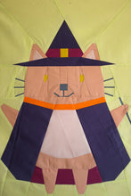 Load image into Gallery viewer, Patchwork design of a fox in a witch costume on a yellow background. The Weekend Quilter Halloween Catwalk Series Hattie Cat Mini Quilt Pattern