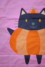 Load image into Gallery viewer, Patchwork cat design on a pink background. The Weekend quilter Halloween Catwalk series Jackie Cat mini Quilt pattern