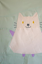 Load image into Gallery viewer, Patchwork quilt block of a cat on a green background. The Weekend Quilter Mistie cat mini quilt pattern from halloween catwalk series