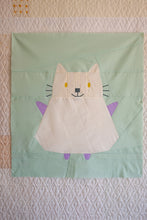 Load image into Gallery viewer, Children&#39;s dress with cat design on a light green background. The Weekend Quilter Mistie cat mini quilt pattern from halloween catwalk series