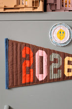 Load image into Gallery viewer, sage green Filing cabinet with decorative magnets and The Weekend Quilter foundation paper pieced 2026 milestone pennant flag.