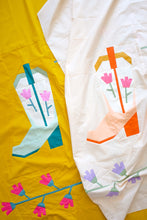 Load image into Gallery viewer, Blushing Boot foundation paper pieced quilt block by The Weekend Quilter, featuring a modern pink and orange cowboy boot with tulip flowers on a soft cream background. Western-themed mini quilt pattern for modern quilters, perfect for wall hangings or incorporating into larger quilt projects. Beginner-friendly FPP design with step-by-step instructions.