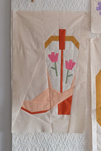 Load image into Gallery viewer, Blushing Boot foundation paper pieced quilt block by The Weekend Quilter, featuring a modern pink and orange cowboy boot with tulip flowers on a soft cream background. Western-themed mini quilt pattern for modern quilters, perfect for wall hangings or incorporating into larger quilt projects. Beginner-friendly FPP design with step-by-step instructions.