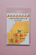 Load image into Gallery viewer, Pack of woven labels with orange cherries design on a pink background