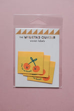 Load image into Gallery viewer, Pack of woven labels with cherry design on a pink background
