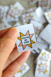 The Weekend Quilter You’re a Star sawtooth star woven labels for handmade and clothing items in ivory and marigold yellow